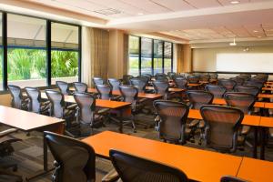 an empty lecture room with tables and chairs at Sheraton Miami Airport Hotel and Executive Meeting Center in Miami