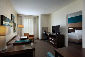 a hotel room with a bed and a living room at Residence Inn by Marriott Austin Southwest in Austin