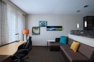 a hotel room with a couch and a table and a desk at Residence Inn by Marriott Austin Southwest in Austin
