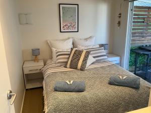 a bedroom with a bed with two pillows on it at Anlyn seaside cabin in Apollo Bay