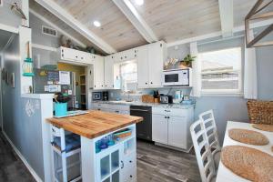 eine Küche mit weißen Schränken und einer Holzarbeitsplatte in der Unterkunft Dream Catcher in Gulf Shores