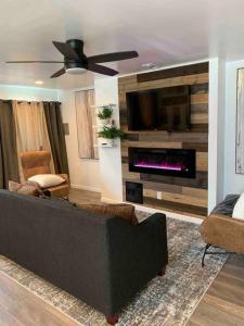 a living room with a couch and a fireplace at Stylish & Cozy Home on the East Side of Pittsburgh 