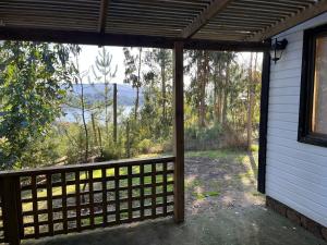 a view from the porch of a house with a fence at Cabaña aquelarre in Vichuquén