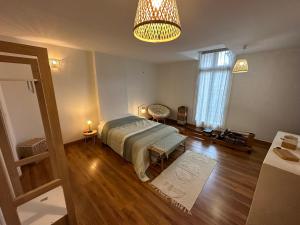 a bedroom with a bed and a large window at Historical center 3 st house, garage & tropeziene in Pézenas