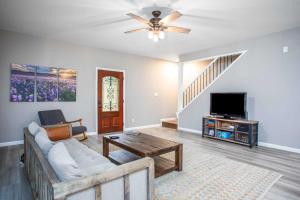 a living room with a couch and a tv at River Rock Retreat in Bandera