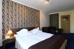 Postel nebo postele na pokoji v ubytování Hotel IKAR