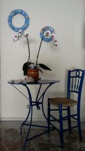 a table and a chair with a potted plant on it at Drakopanagiotaki Rooms in Agios Andreas +46 photos