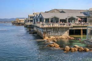 a group of people standing on a pier over the water at 3896 Gather and Rest home in Del Rey Oaks