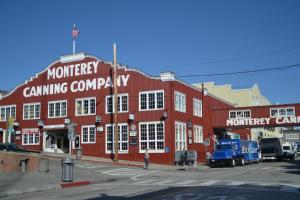 a red building with a truck parked in front of it at 3896 Gather and Rest home in Del Rey Oaks