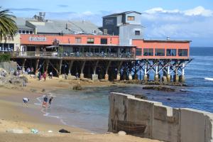 a pier with people on the beach near the ocean at 3896 Gather and Rest home in Del Rey Oaks