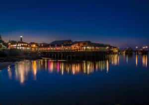 a wooden bridge over a body of water at night at 3896 Gather and Rest home in Del Rey Oaks