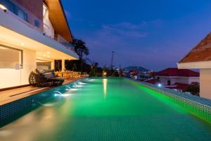 a swimming pool in a villa at night at Cosa villages in Vung Tau