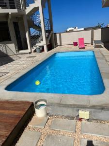 una piscina azul con una bola amarilla. en John House studio No 8, en Flic en Flac