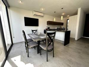 a kitchen and dining room with a table and chairs at Modern Beautiful Condo in Mezcales