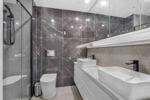 a bathroom with a sink and a toilet and a shower at Home*walking Chadstone shopping centre in Chadstone