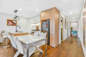 a kitchen and dining room with a white table and chairs at Home*walking Chadstone shopping centre in Chadstone