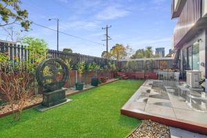 a backyard with green grass and a fence at Home*walking Chadstone shopping centre in Chadstone