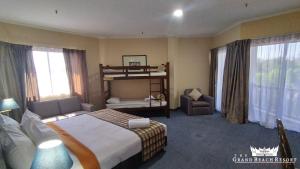 Habitación de hotel con cama y silla en The Grand Beach Resort Port Dickson, en Port Dickson