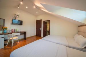 Voodi või voodid majutusasutuse Tasme Hotel toas