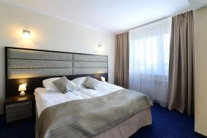 Postel nebo postele na pokoji v ubytování Hotel IKAR