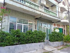 a building with windows and bushes and a balcony at The whole house not share for 5 guests in Hat Yai