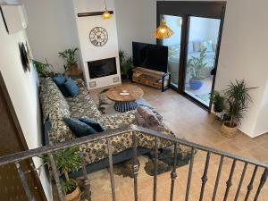 a living room with a couch and a tv at Casa Christiana, Lardos in Lartos