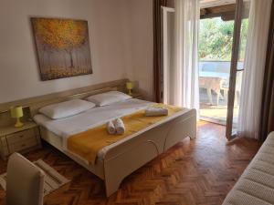 a bedroom with a bed with two towels on it at Apartments Ivo in Pag