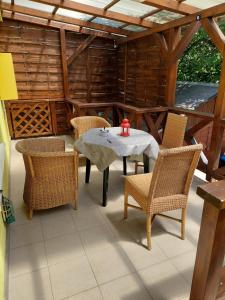 a patio with a table with chairs and a red candle at Dizike Pet-friendly Guesthouse in Budapest