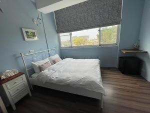 Posteľ alebo postele v izbe v ubytovaní 臺南安平 -安平安逸民宿 Anping Guest House