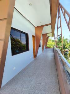 a staircase leading up to a house with large windows at RNEK Boatel Commercial Space in Moalboal