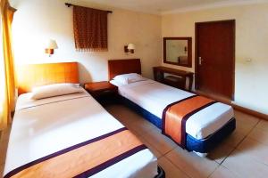 Postel nebo postele na pokoji v ubytování Horison Resort Pondok Layung Anyer
