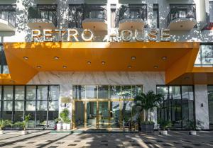a hotel with a large yellow sign on the facade at Petro House Vung Tau in Vung Tau