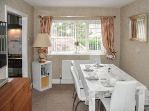 a kitchen and dining room with a table and chairs at Coastal Retreat - Uk37827 in Bare