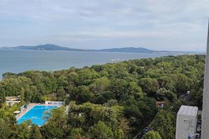 an aerial view of a swimming pool and a lake at SEA VIEW FLORA in Burgas