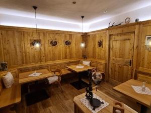 a restaurant with wooden walls and tables and lights at Apartments Morandell in Fulpmes