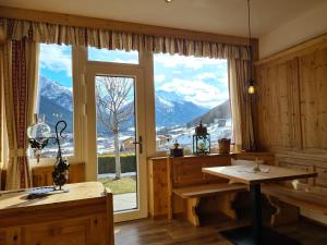 a room with a large window with a view of mountains at Apartments Morandell in Fulpmes