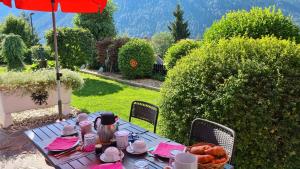 a blue table with a basket of fruit and an umbrella at Apartments Morandell in Fulpmes