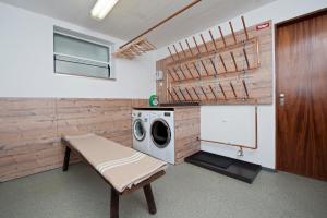 a laundry room with a washing machine and a washer at Gästehaus Morandell in Fulpmes