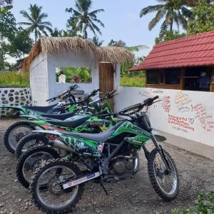 a row of motorcycles parked in front of a building at Tetebatu Sama Sama Bungalows in Tetebatu