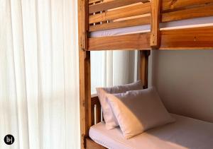 a bunk bed with a pillow on the bottom bunk at BAAN650 Hostel in Hat Yai +24 photos