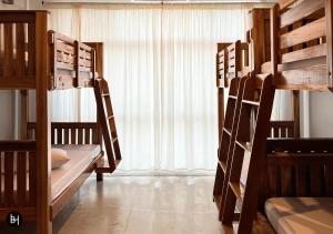 a room with four bunk beds and a window at BAAN650 Hostel in Hat Yai