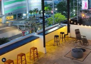 a view of a building with stools and a bar at BAAN650 Hostel in Ban Kohong