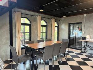 a dining room with a wooden table and chairs at Blessing Moon Pool Villa Khaoyai in Ban Tha Wua Tai