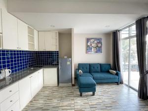 a living room with a blue couch in a kitchen at ANANTAYA CHIANGMAI BOUTIQUE HOTEL in Chiang Mai