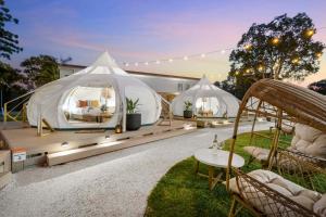 a group of white tents in a yard at Ingenia Holidays Byron Bay in Byron Bay