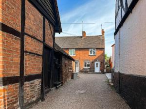 an alley between two brick buildings with a house at Star Yard in Tenbury