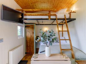 a bunk bed in a tiny house with a vase on a table at Foxglove - Uk37639 in Bradbourne