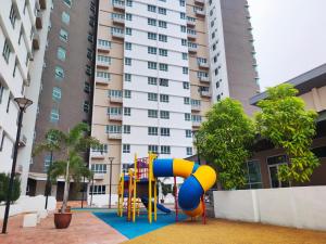 a playground in front of a large building at Cosy Apartment Ipoh Town - WiFi Netflix FREE in Ipoh