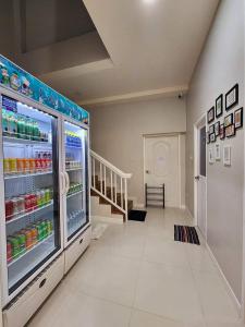 a room with a refrigerator with drinks in it at PPhouse Boutique House Phuket Town in Ban Bang Khu