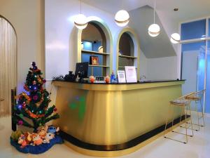 a christmas tree sitting in front of a counter at PPhouse Boutique House Phuket Town in Ban Bang Khu